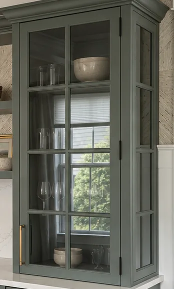 Glass cabinet door with divided panes, meeting the wall and the ceiling molding